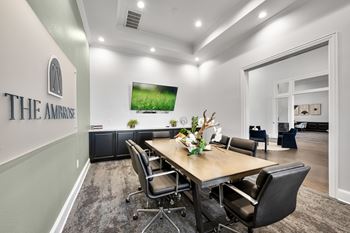 A conference room with a long table surrounded by chairs. at The Ambrose, Houston